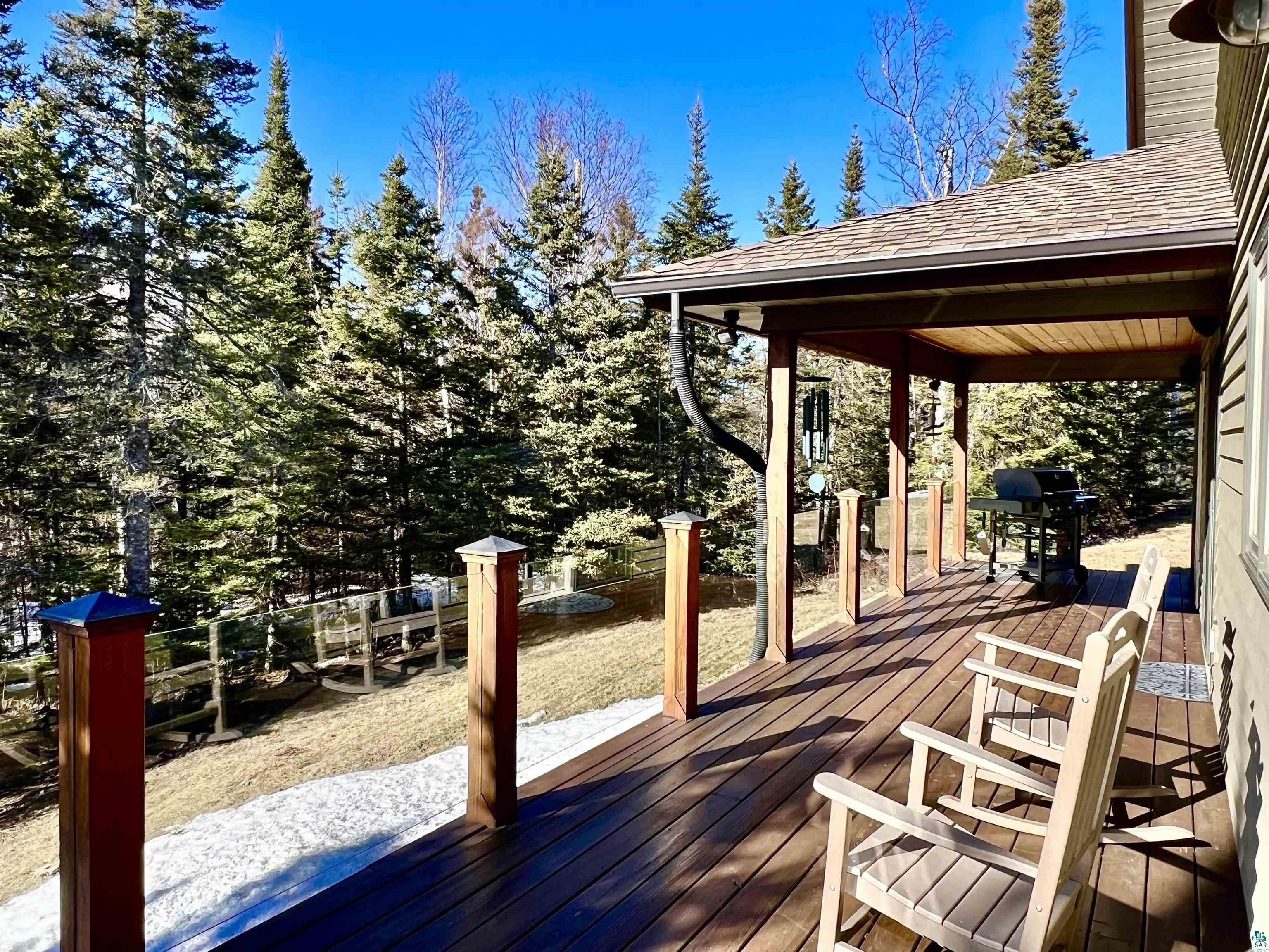 21 Turnagain Trail Lutsen, MN 55612 - Photo 50 of 77 Covered porch featuring a composite deck, recessed lighting, and a wood-finish ceiling