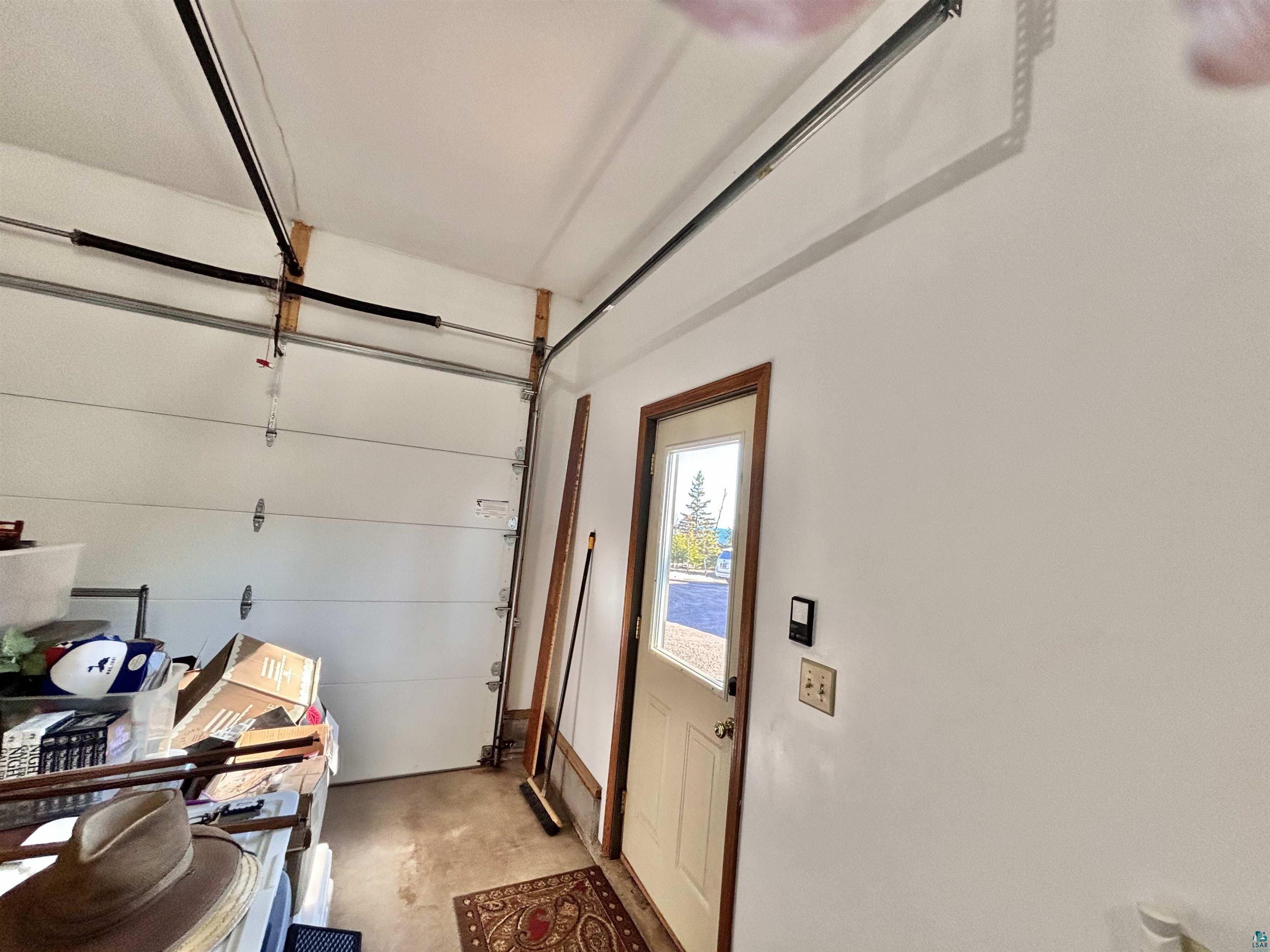 21 Turnagain Trail Lutsen, MN 55612 - Photo 63 of 77 Interior garage space with painted white walls and exposed ceiling-mounted garage door track system