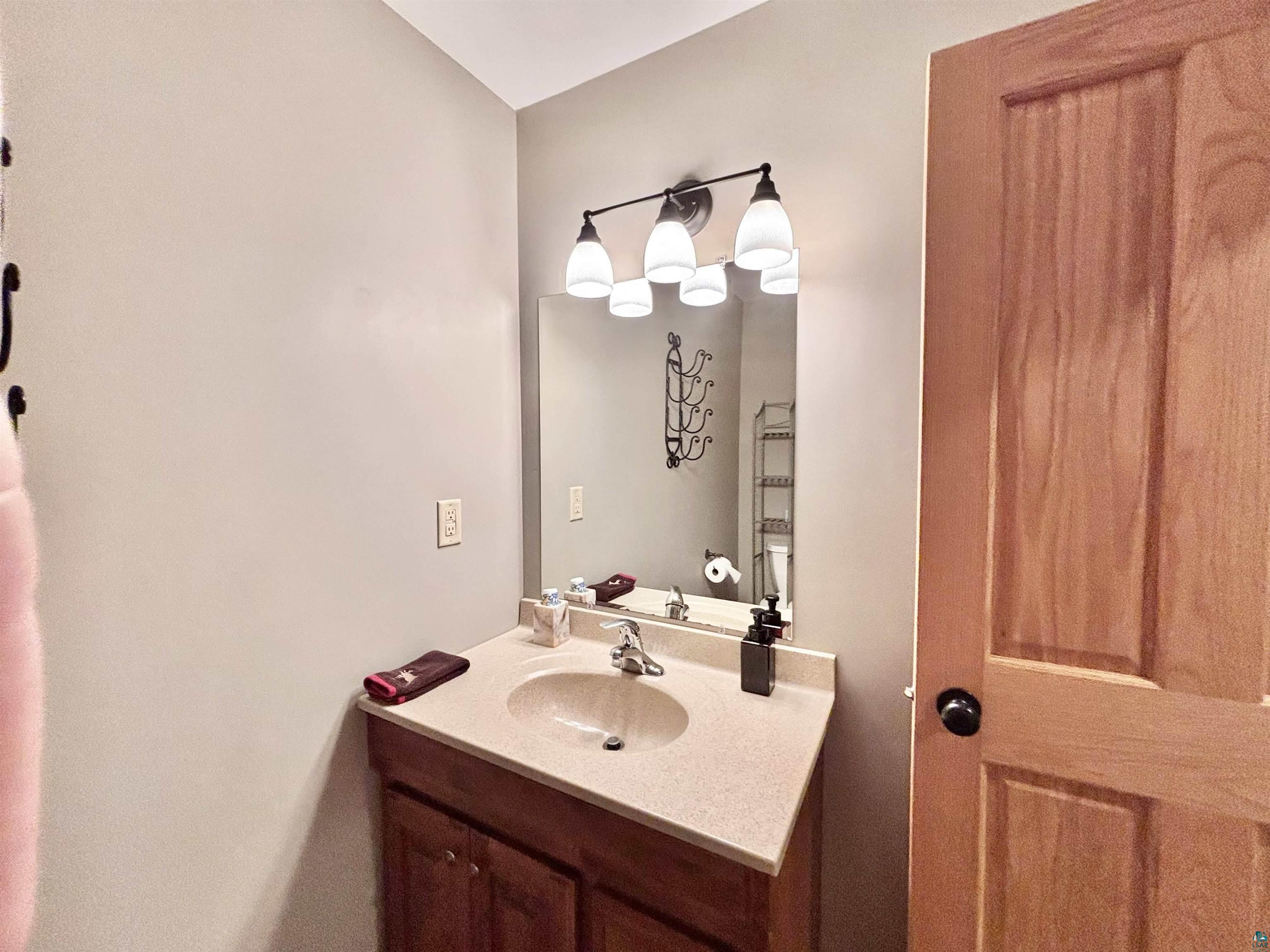 21 Turnagain Trail Lutsen, MN 55612 - Photo 64 of 77 Bathroom vanity with a light-toned countertop and an integrated sink