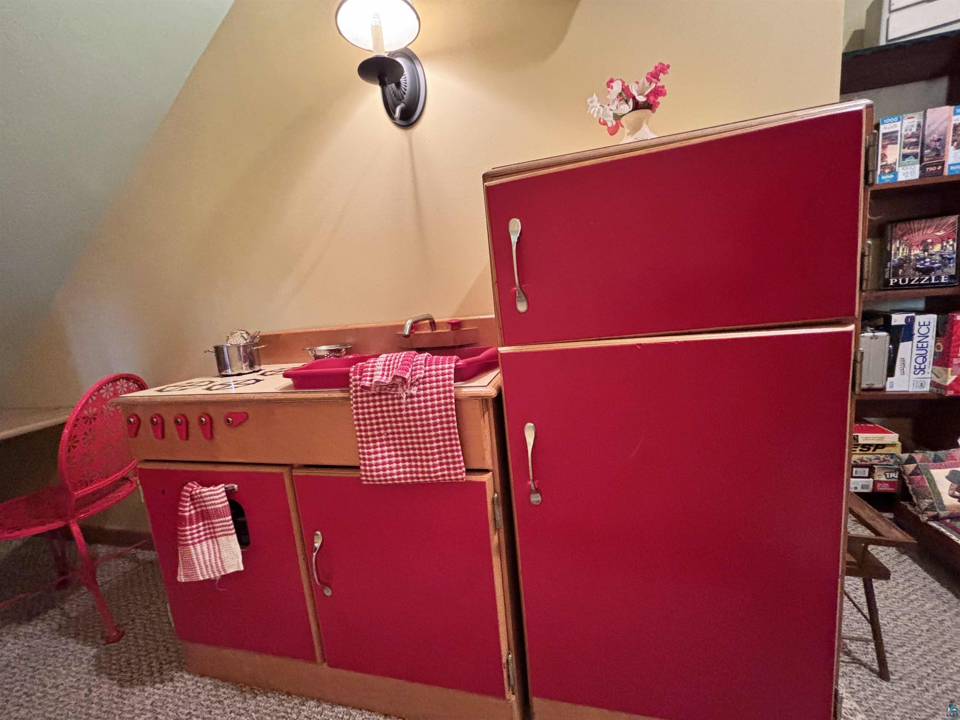 21 Turnagain Trail Lutsen, MN 55612 - Photo 67 of 77 Custom-built kitchenette featuring red cabinetry, wood-finish countertops, built-in sink, and wall-mounted lighting fixture