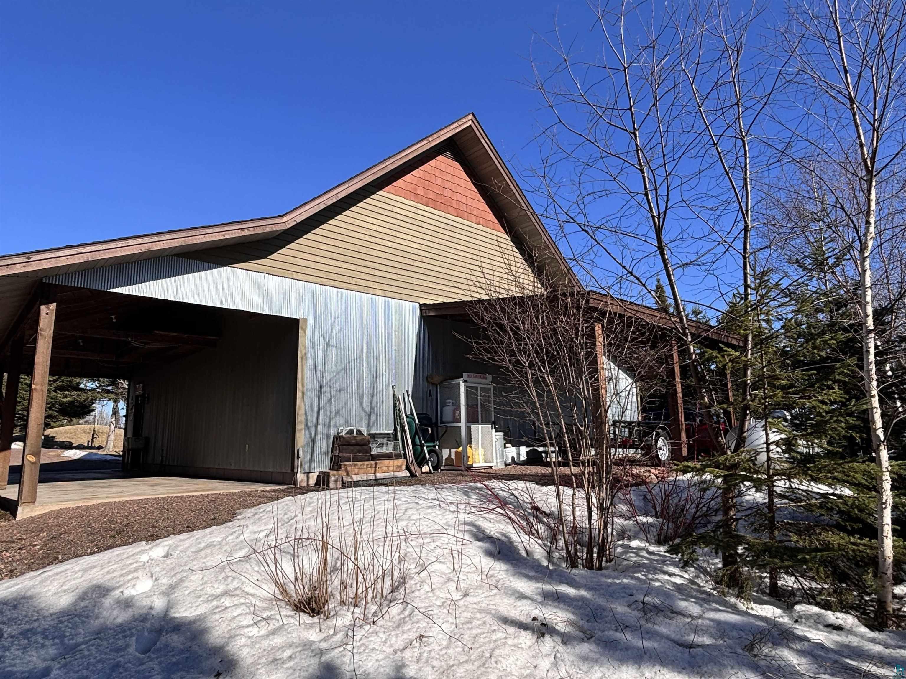 21 Turnagain Trail Lutsen, MN 55612 - Photo 72 of 77 Carport structure featuring a wooden frame and exposed rafters