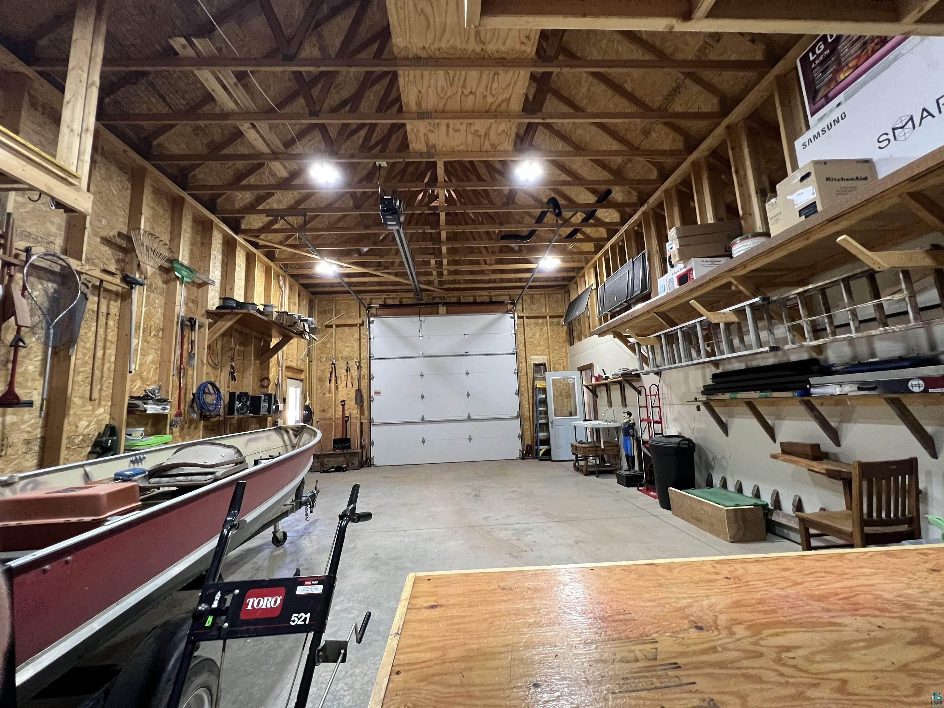 21 Turnagain Trail Lutsen, MN 55612 - Photo 75 of 77 Spacious garage featuring exposed wood beam ceilings and wood-paneled walls
