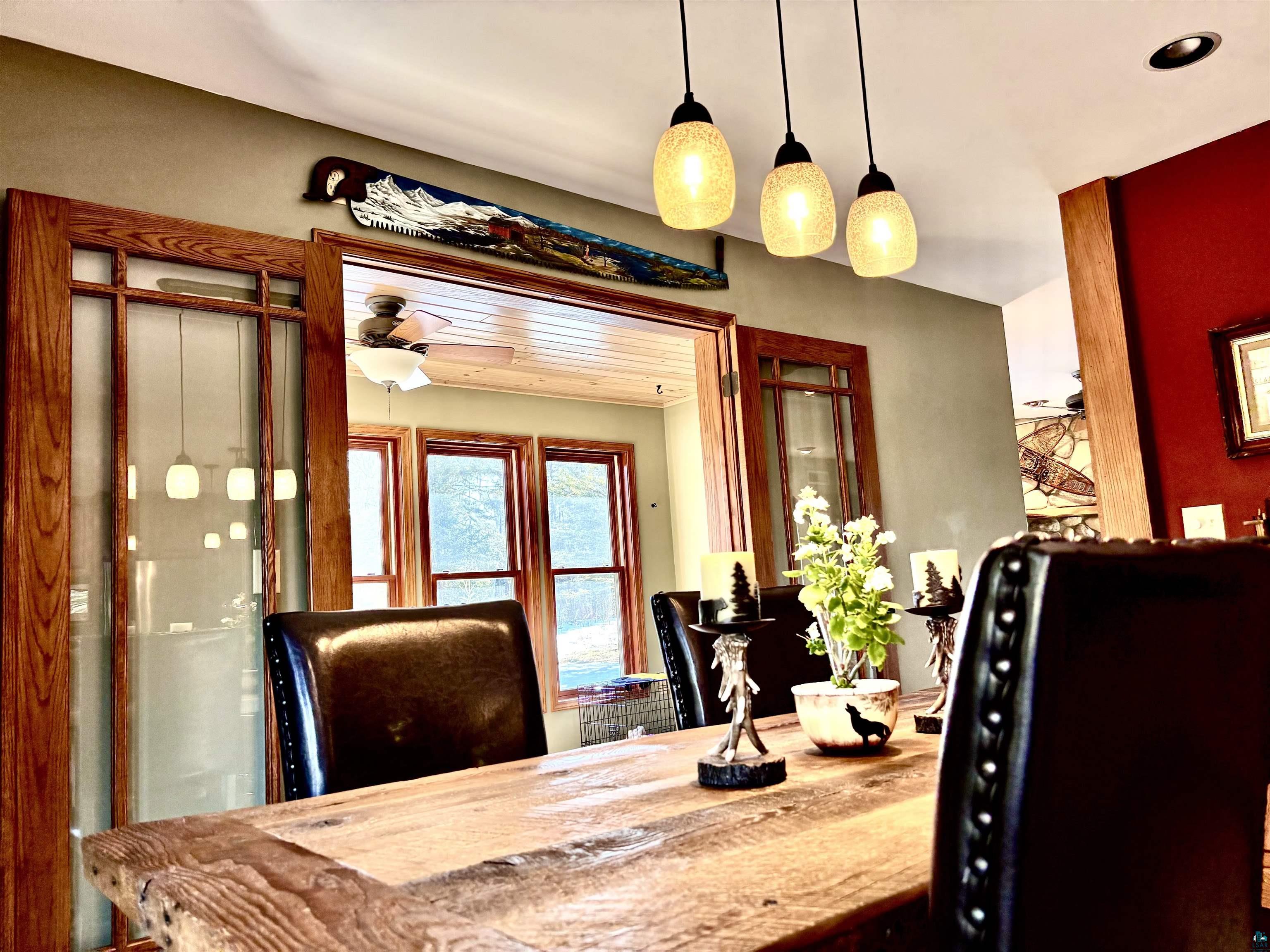 21 Turnagain Trail Lutsen, MN 55612 - Photo 9 of 77 Dining area with a rustic wood-finish table and leather-style chairs