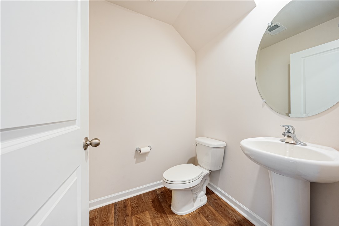 404 Oakmont Valley Trail Seneca, SC 29678 - Photo 14 of 44 This clean and bright powder room features a pedestal sink and modern fixtures, creating a crisp atmosphere.