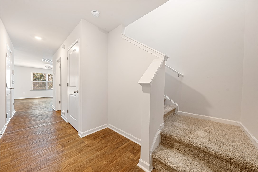 404 Oakmont Valley Trail Seneca, SC 29678 - Photo 15 of 44 This bright hallway connects to a carpeted staircase, creating an inviting flow.