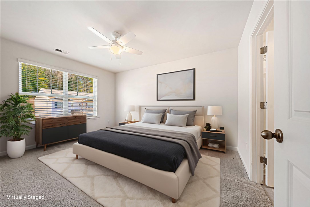 404 Oakmont Valley Trail Seneca, SC 29678 - Photo 17 of 44 This airy bedroom offers serene comfort and abundant natural light for peaceful relaxation.