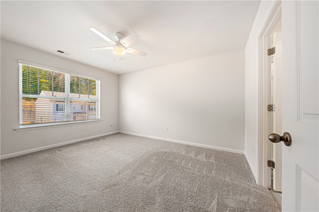404 Oakmont Valley Trail Seneca, SC 29678 - Photo 18 of 44 This spacious room features a window overlooking lush greenery, offering a serene retreat.