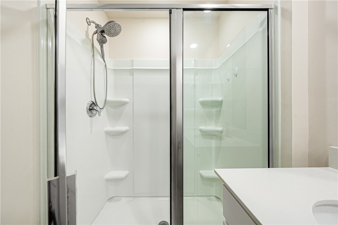 404 Oakmont Valley Trail Seneca, SC 29678 - Photo 21 of 44 This clean, bright bathroom features a modern shower enclosure with convenient built-in shelving.
