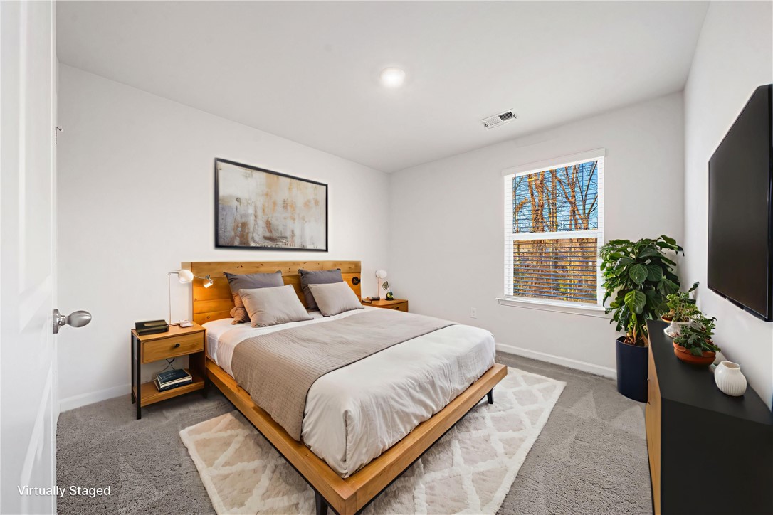 404 Oakmont Valley Trail Seneca, SC 29678 - Photo 24 of 44 This inviting bedroom features a cozy bed and ample natural light, creating a serene personal retreat.