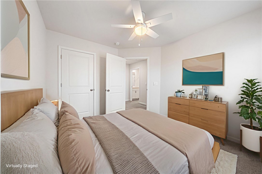 404 Oakmont Valley Trail Seneca, SC 29678 - Photo 29 of 44 This bright bedroom features soft carpet and a cooling ceiling fan, offering a comfortable and serene retreat.
