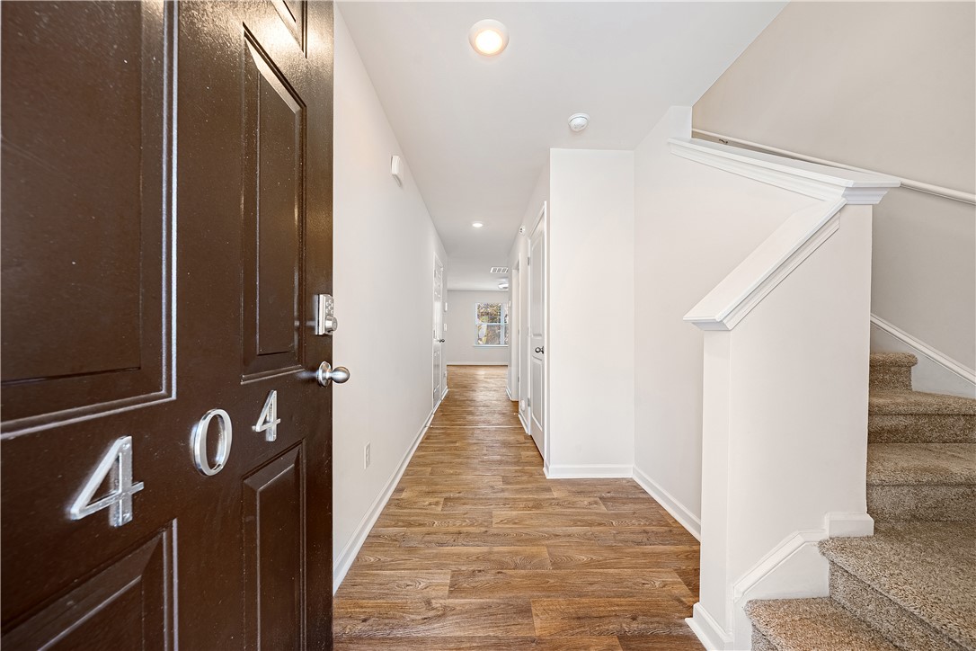 404 Oakmont Valley Trail Seneca, SC 29678 - Photo 3 of 44 The inviting entryway features durable flooring and leads to a carpeted staircase.