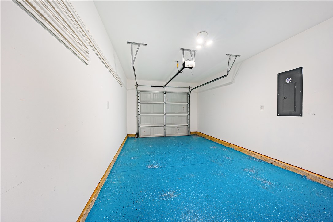 404 Oakmont Valley Trail Seneca, SC 29678 - Photo 31 of 44 Bright and spacious garage with a vibrant blue floor, ready for your vehicles and storage needs.