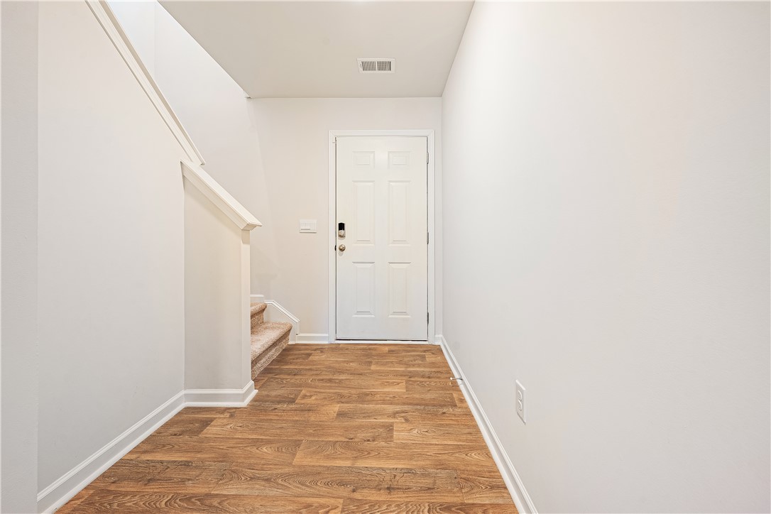 404 Oakmont Valley Trail Seneca, SC 29678 - Photo 4 of 44 This bright entry offers a welcoming atmosphere with durable flooring and convenient staircase access.