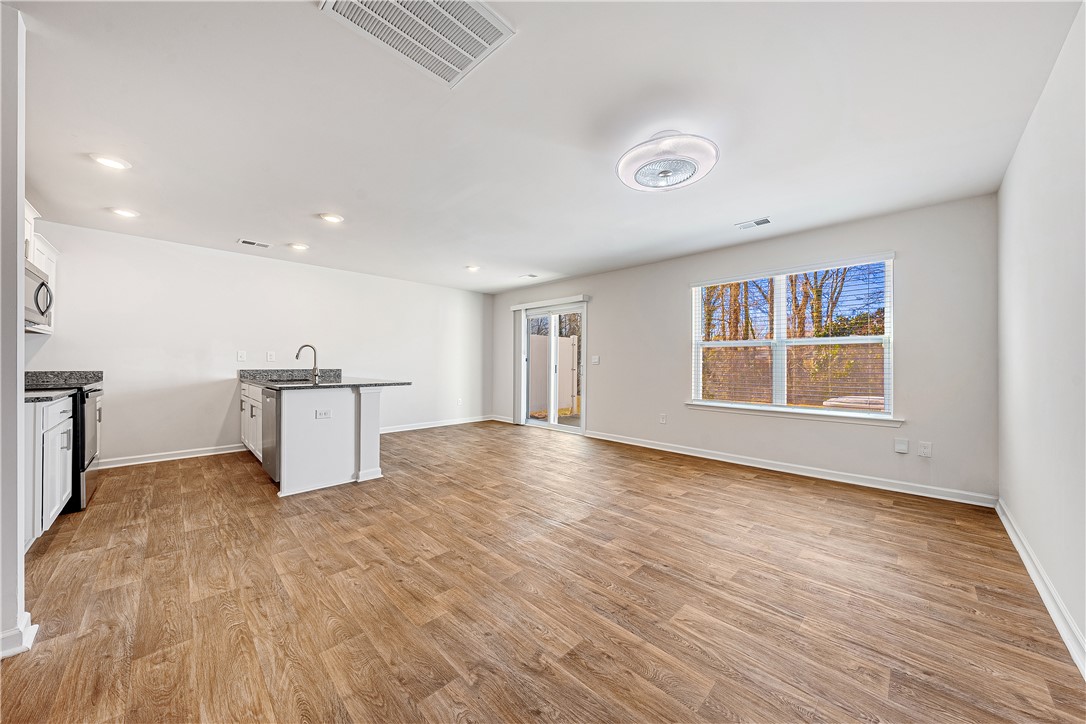 404 Oakmont Valley Trail Seneca, SC 29678 - Photo 6 of 44 This bright, open-concept living space features durable flooring and direct outdoor access.