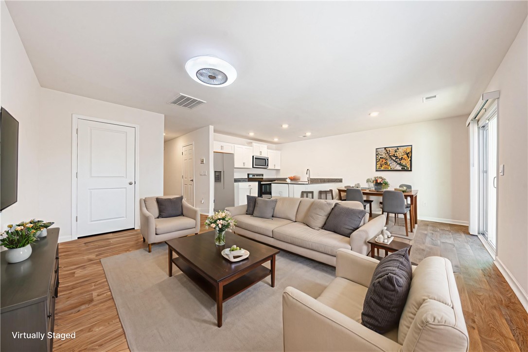 404 Oakmont Valley Trail Seneca, SC 29678 - Photo 7 of 44 This bright and open-concept living space features warm flooring and ample natural light.