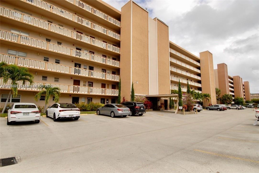 300 Northeast 12th Avenue, Unit 101 Hallandale Beach, FL 33009 - Photo 1 of 23 a cars parked in front of a building