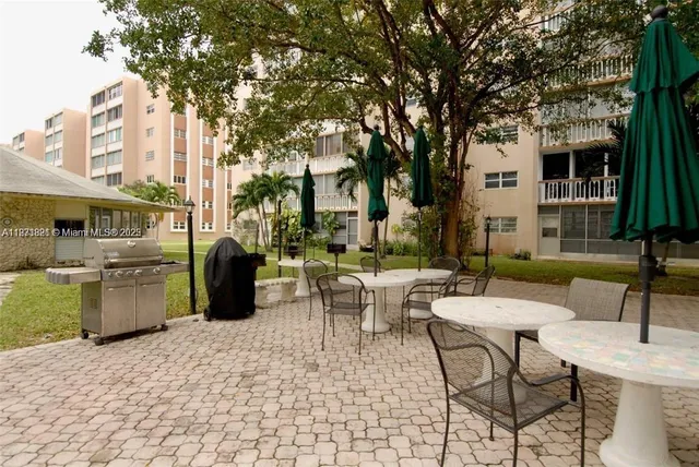 a view of a patio with couches table and chairs and potted plants
