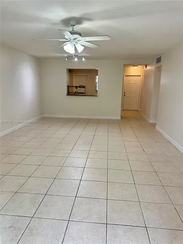 a view of a livingroom with a chandelier fan and furniture