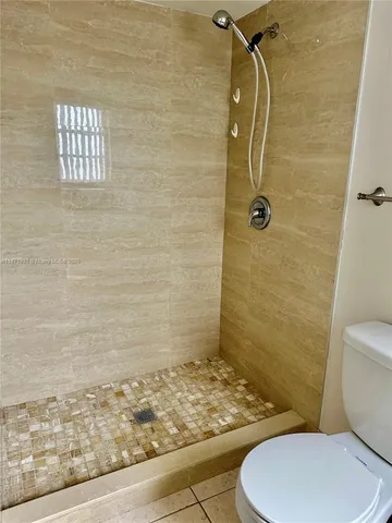 a bathroom with a toilet and shower