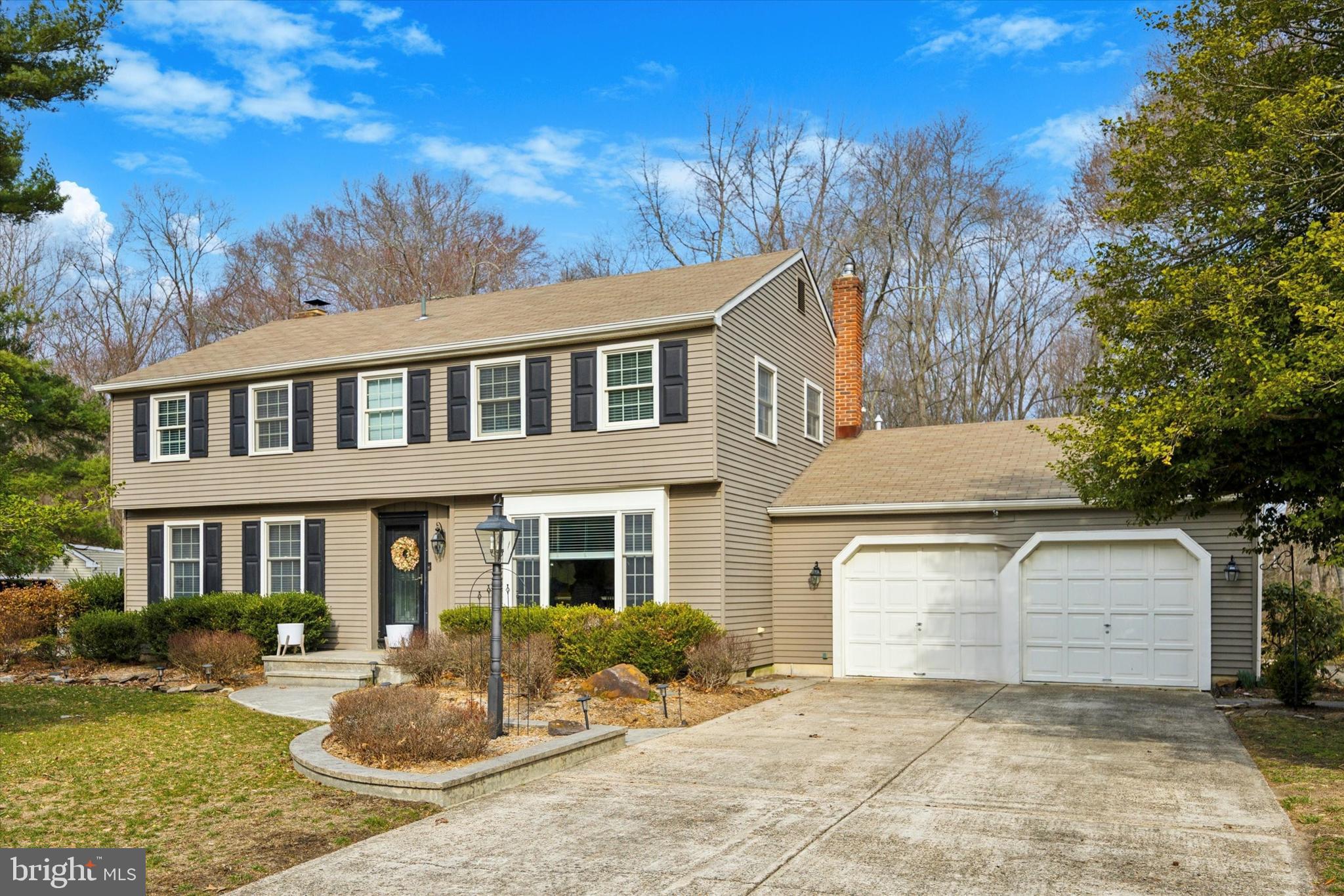 a front view of a house with yard fire pit and outdoor seating