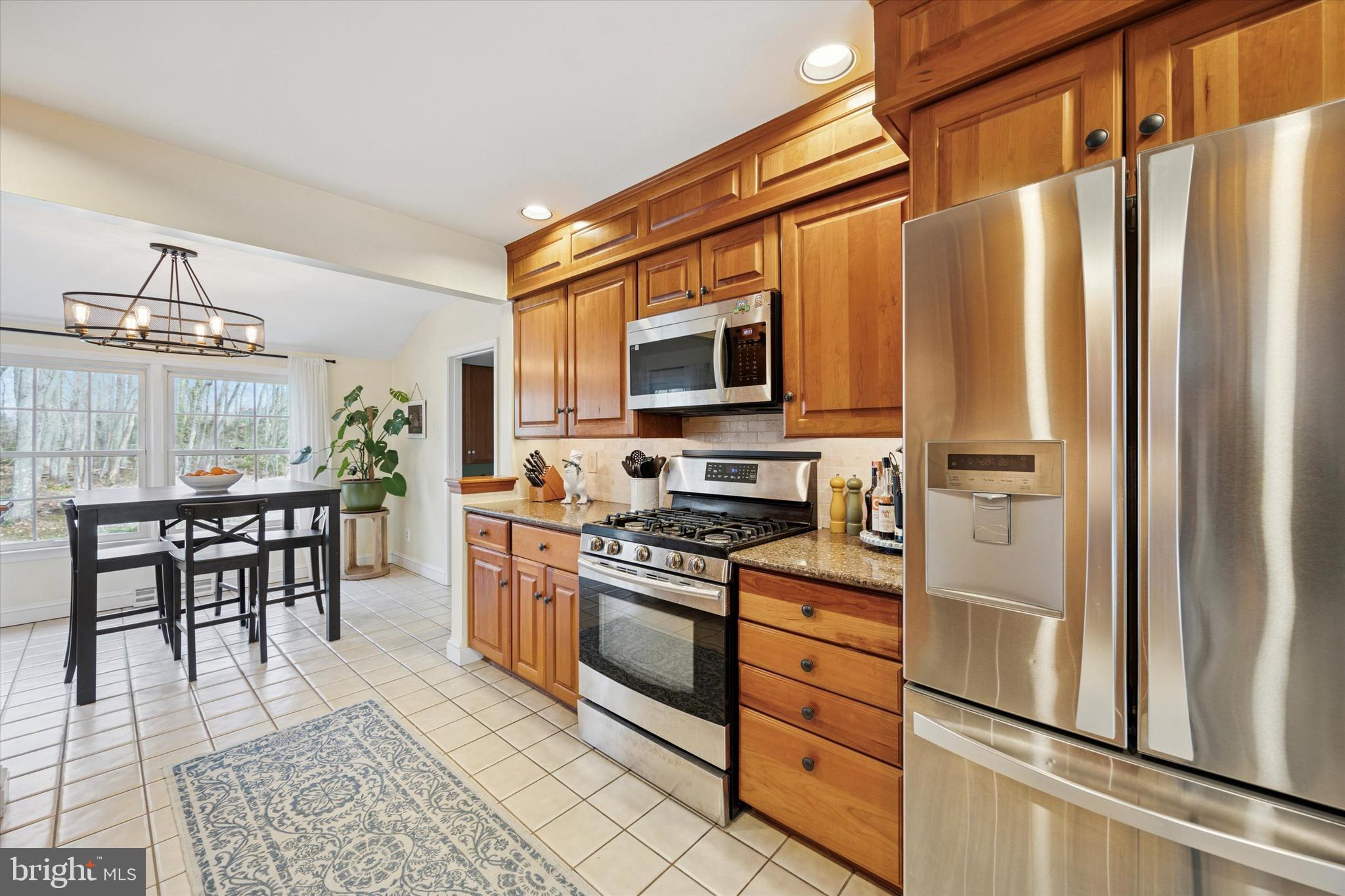 22 Schoolhouse Drive Medford, NJ 08055 - Photo 11 of 26 a kitchen with stainless steel appliances a stove microwave and a refrigerator
