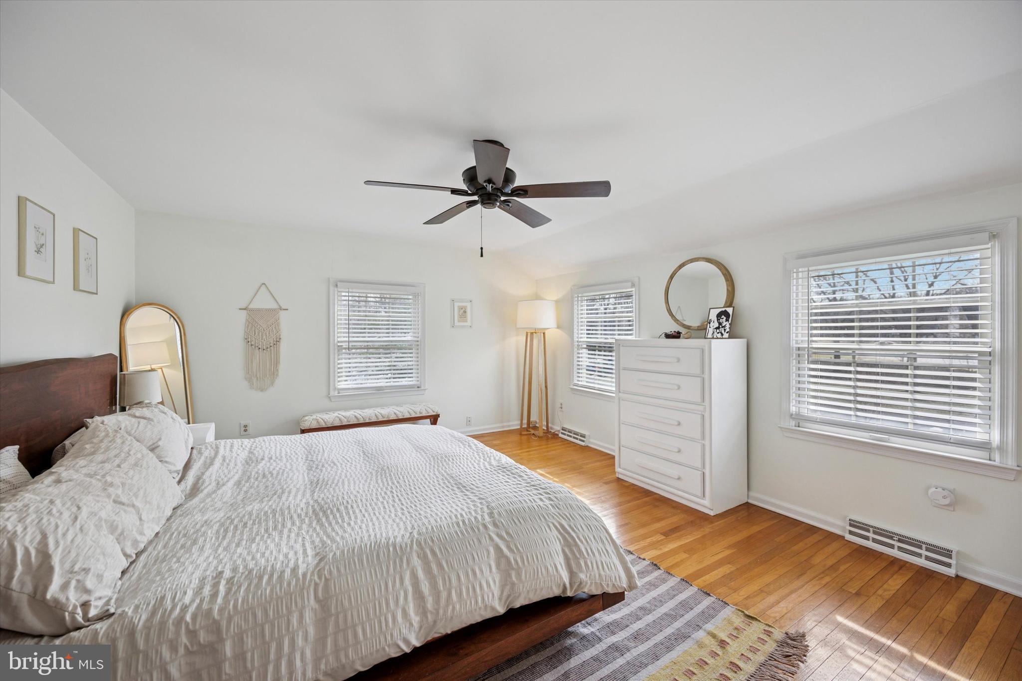 22 Schoolhouse Drive Medford, NJ 08055 - Photo 15 of 26 a bedroom with a bed ceiling fan and wooden floor