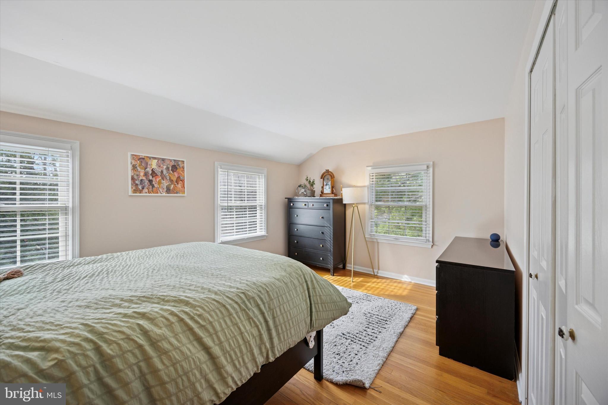 22 Schoolhouse Drive Medford, NJ 08055 - Photo 19 of 26 a spacious bedroom with a bed and wooden floor
