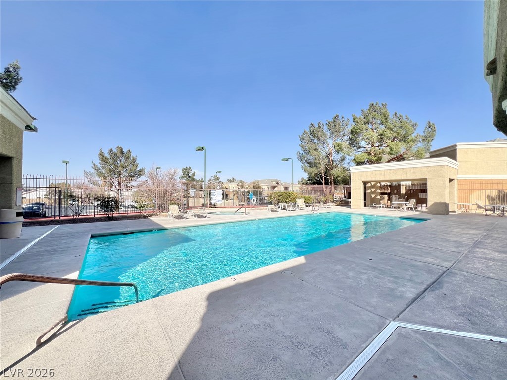 8070 West Russell Road, Unit 2070 Las Vegas, NV 89113 - Photo 22 of 27 Community Pool with a patio and fence