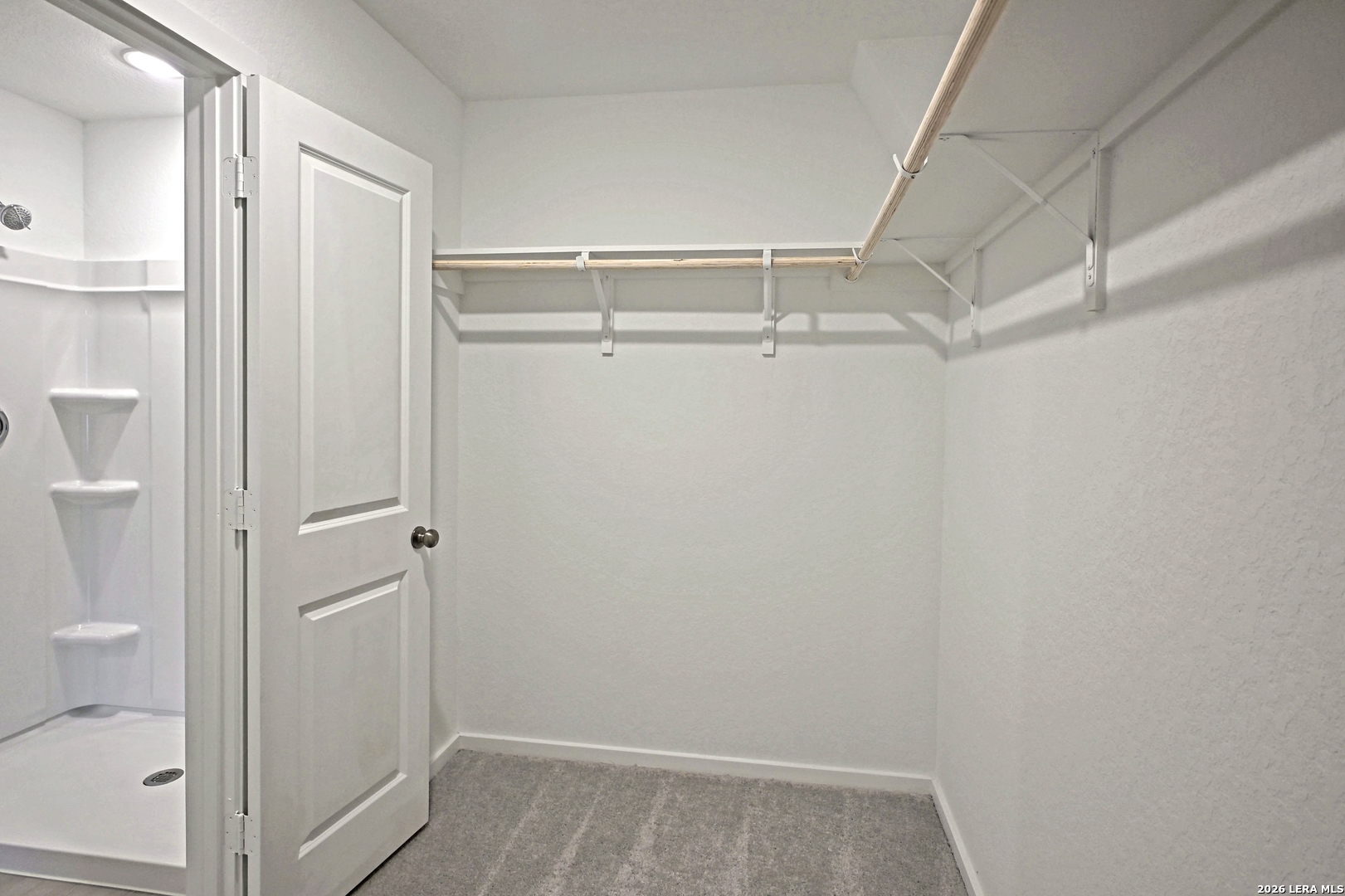 9902 Mather Way Converse, TX 78109 - Photo 11 of 18 a view of walk in closet with empty racks