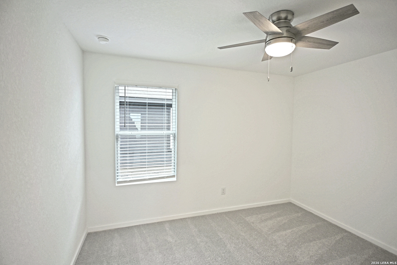 9902 Mather Way Converse, TX 78109 - Photo 13 of 18 an empty room with a window and a fan