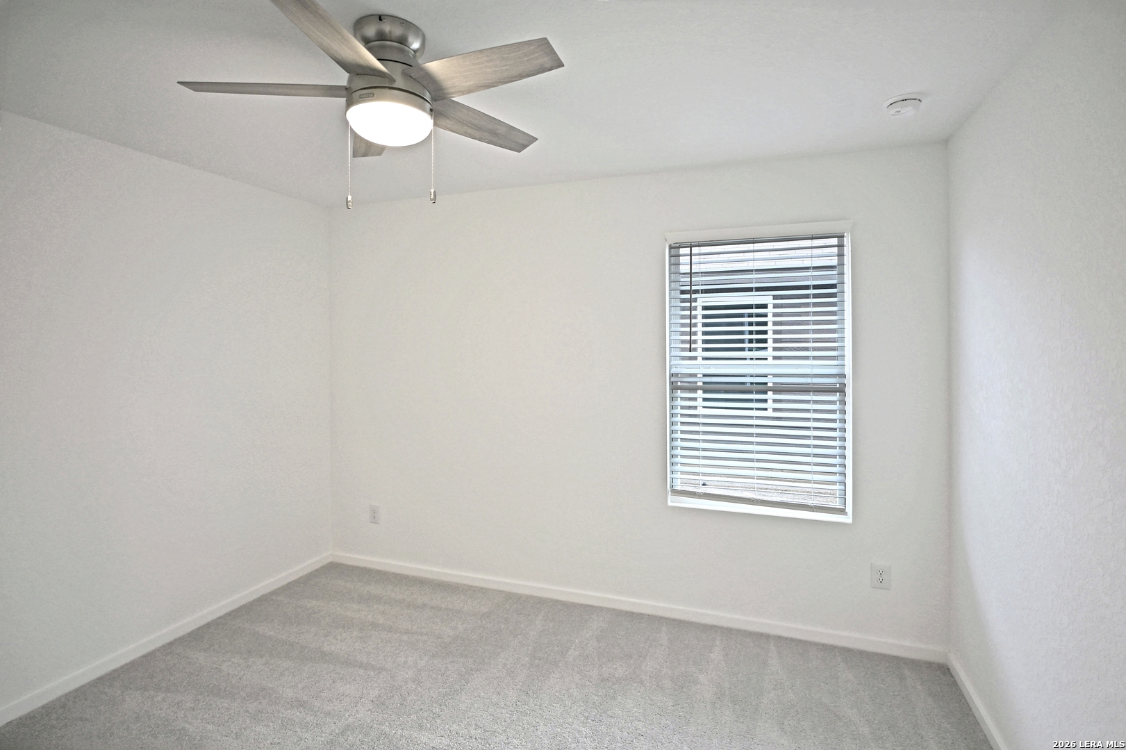 9902 Mather Way Converse, TX 78109 - Photo 16 of 18 an empty room with a window and a fan