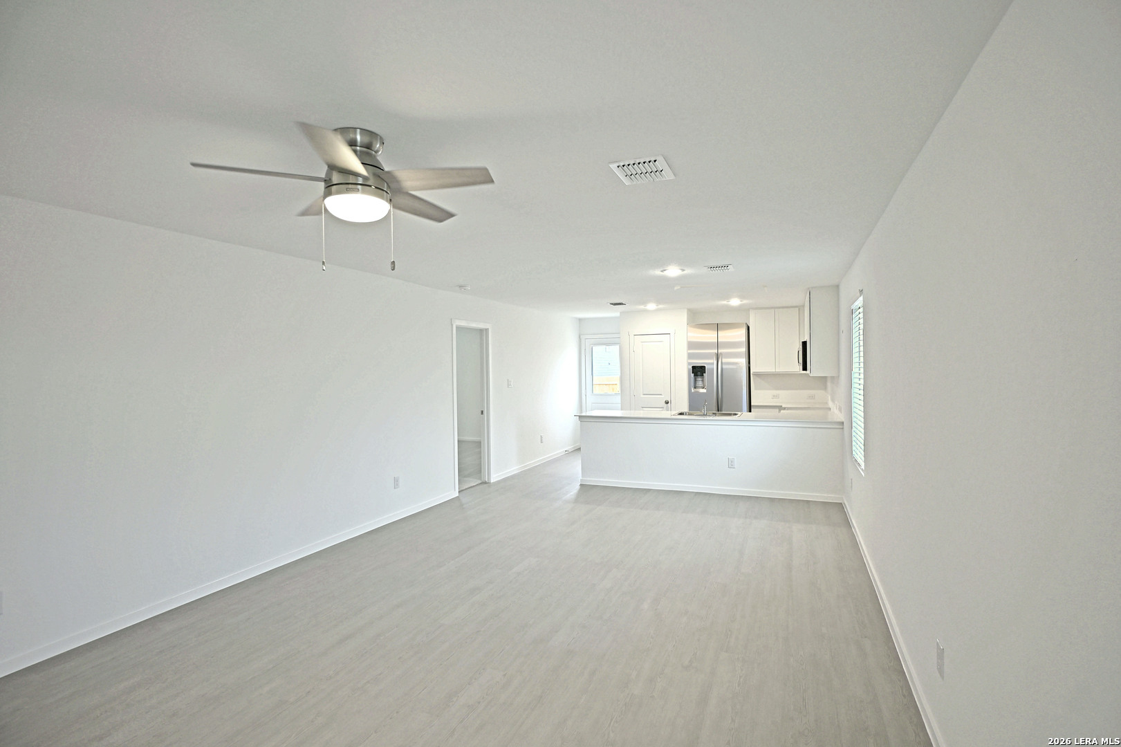 9902 Mather Way Converse, TX 78109 - Photo 3 of 18 a view of a hallway with wooden floor and a kitchen
