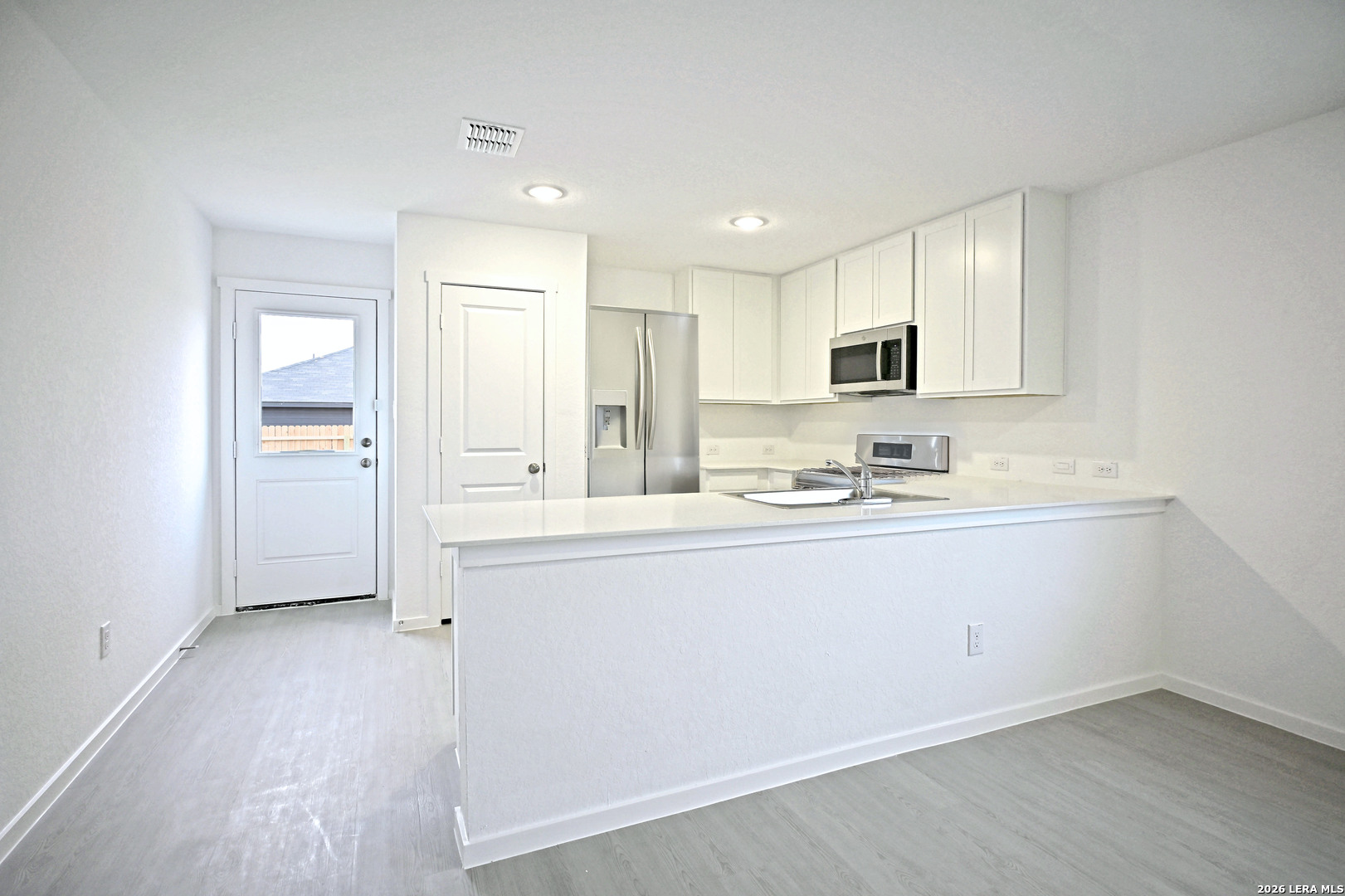 9902 Mather Way Converse, TX 78109 - Photo 5 of 18 a kitchen with granite countertop white cabinets and white appliances