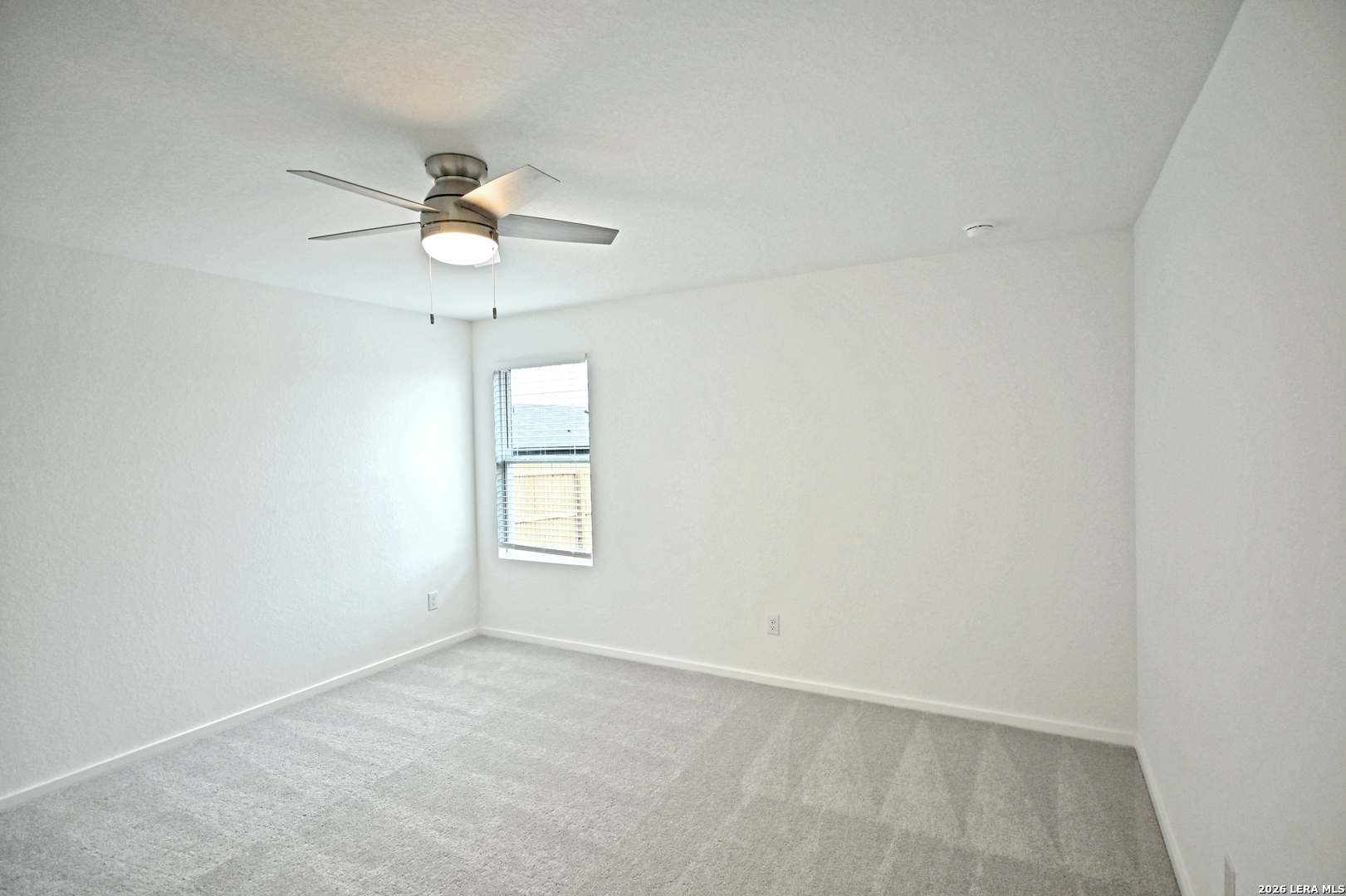 9902 Mather Way Converse, TX 78109 - Photo 7 of 18 an empty room with a window and a ceiling fan