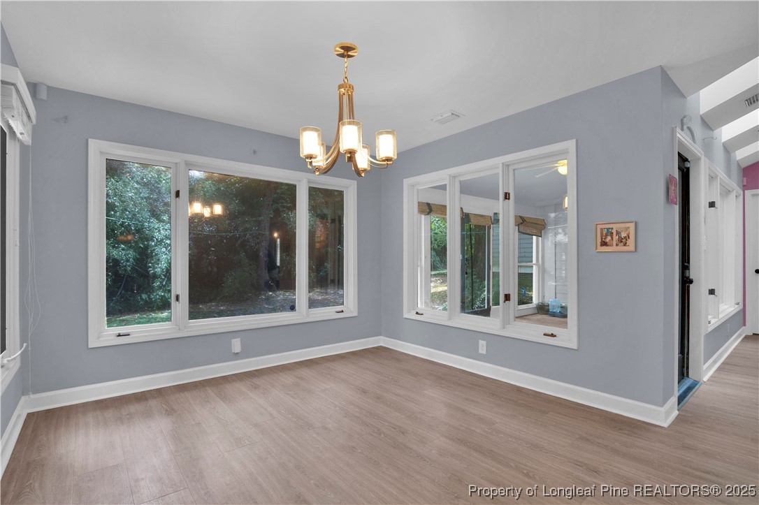 2375 Raeford Road Fayetteville, NC 28305 - Photo 6 of 39 a view of a room with large windows and wooden floor
