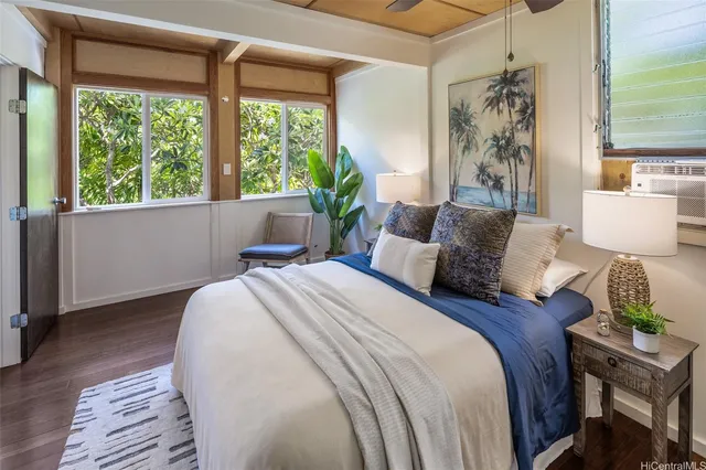 a bed sitting in a bedroom next to a window