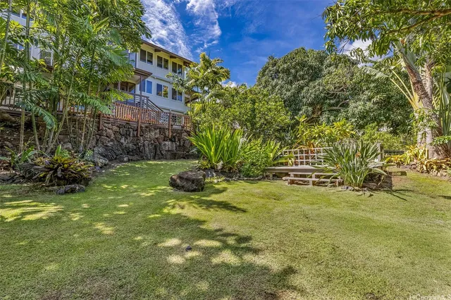 a backyard of a house with table and chairs