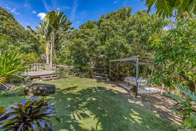 a backyard of a house with table and chairs