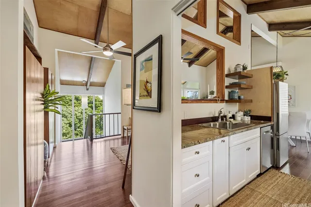 a hallway with sink and mirror