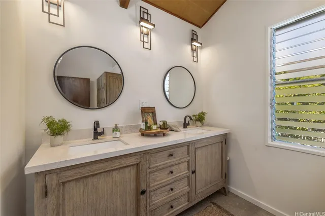 a bathroom with a double vanity sink and a mirror