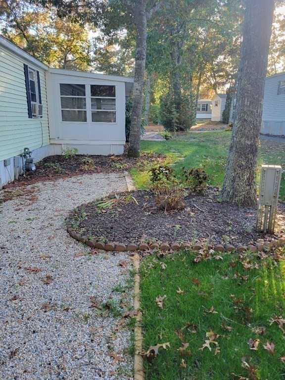 197 Windswept Road Wareham, MA 02571 - Photo 22 of 26 a view of a backyard with large trees and plants