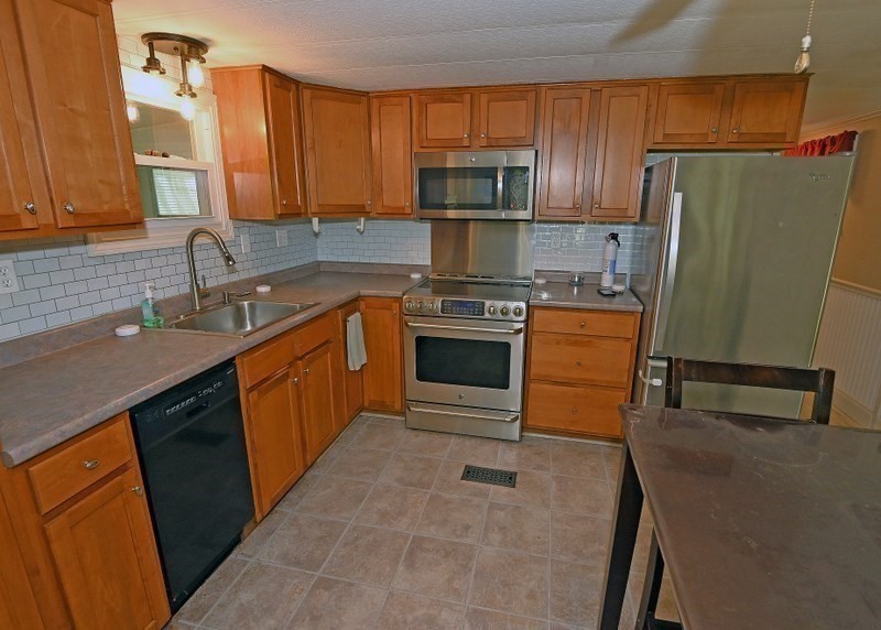 197 Windswept Road Wareham, MA 02571 - Photo 8 of 26 a kitchen with stainless steel appliances granite countertop a sink stove and refrigerator