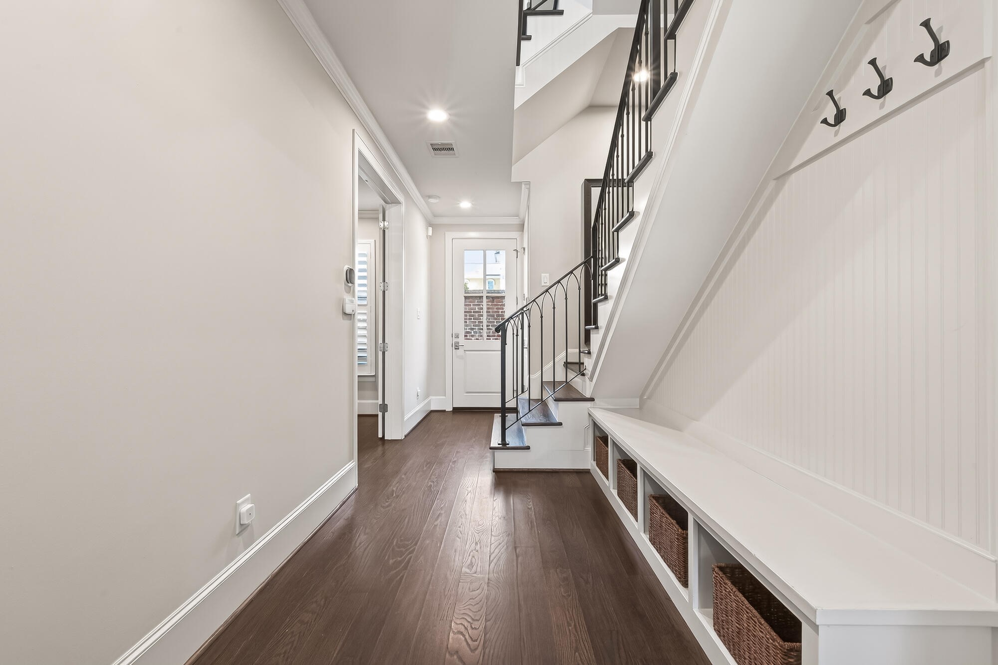 122 Gateway Park Place Spring, TX 77380 - Photo 6 of 44 Freshly painted entry hall showcases upgraded wood floors, built-in bench storage, and elegant iron staircase.