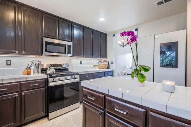 a living room with furniture a fireplace and a large window