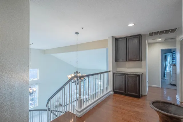 a bedroom with a bed and large windows