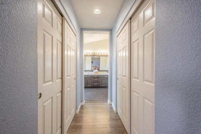 a spacious bathroom with double vanity and a mirror