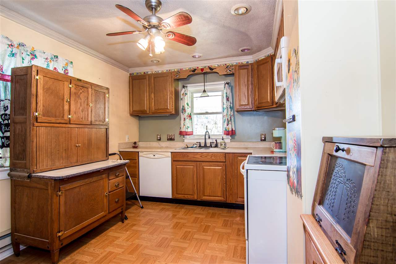 7708 Briery Branch Road Dayton, VA 22821 - Photo 8 of 25 a kitchen with a refrigerator a sink dishwasher and a stove with wooden floor