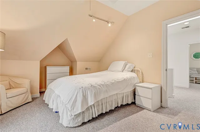 a bedroom with a bed and a couch