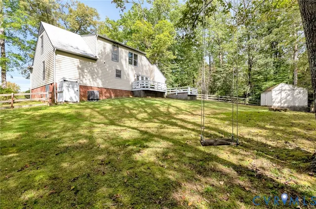 a view of a house with a yard and sitting area