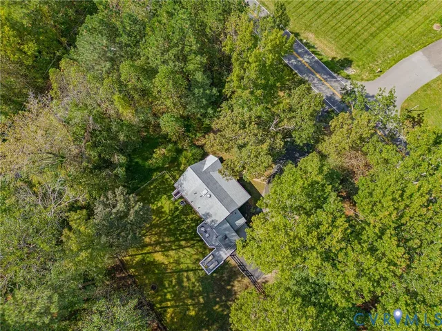 an aerial view of a house with a yard